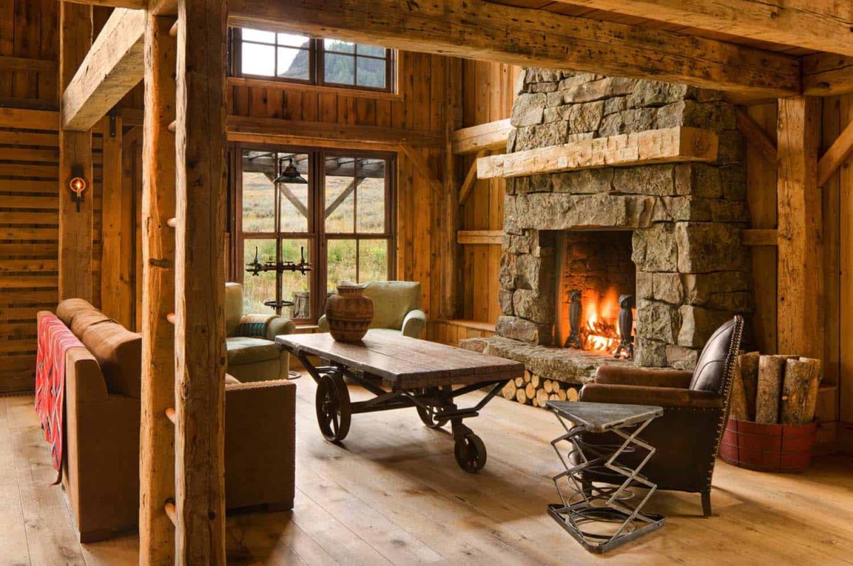 The focal point of the living room is a large stone-clad fireplace which covers almost an entire wall