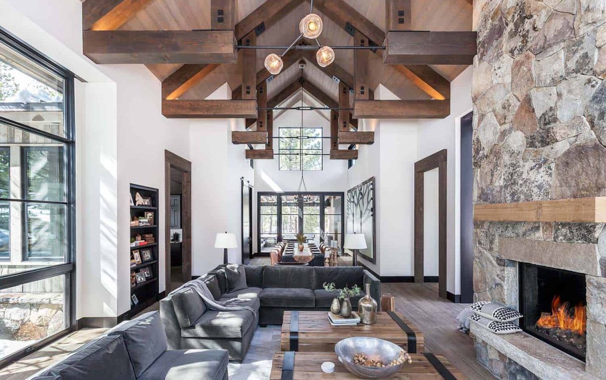 The stone fireplace and wooden ceiling add texture to the decor and create a cozy, rustic vibe