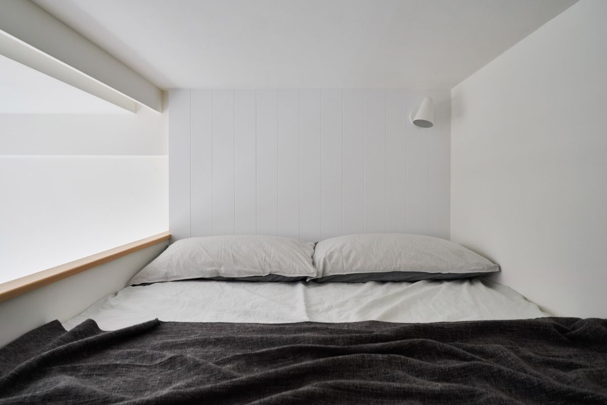 The mezzanine floor is super minimalist, with nothing more than a mattress and a wall-mounted sconce