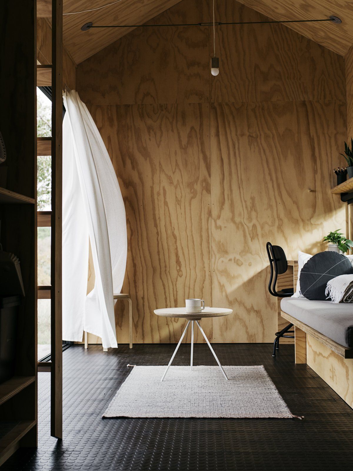 Inside, the cabin features plywood-covered walls, a matching ceiling and rubber floor tiles