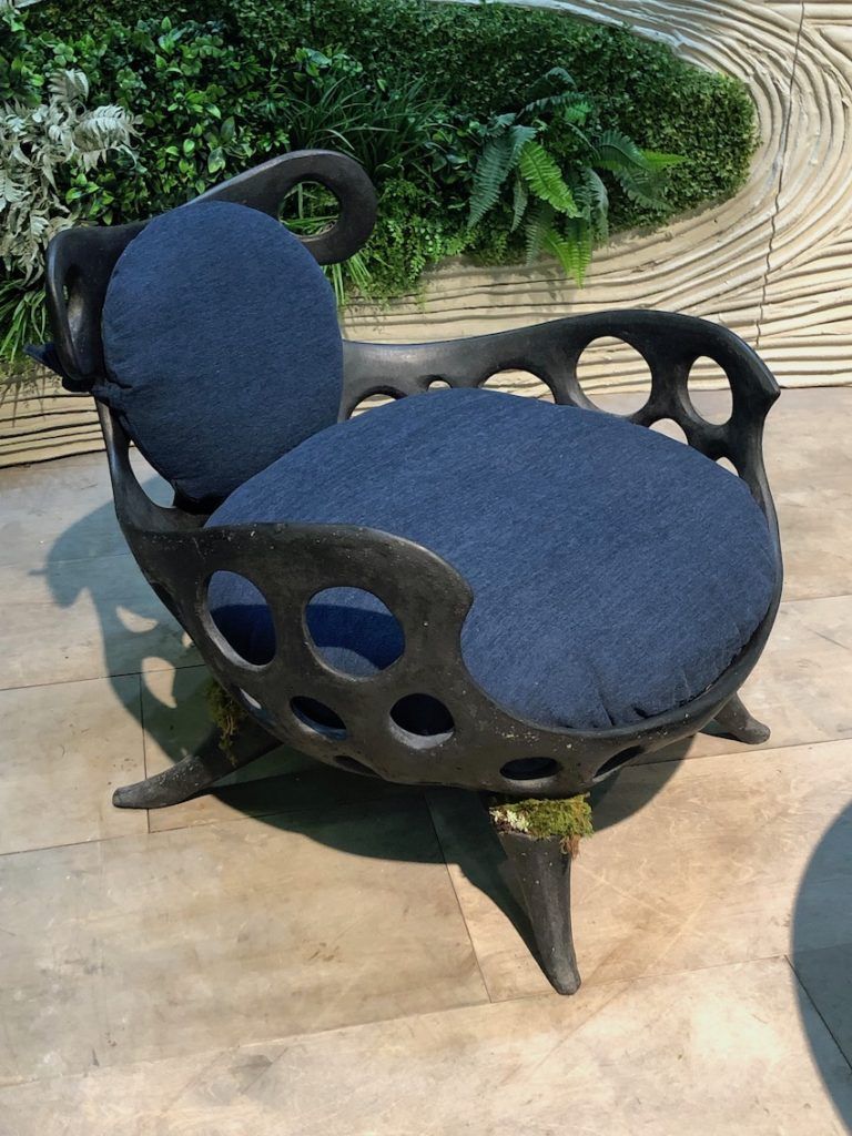 A whimsical chair shape includes pockets for planting some greenery.