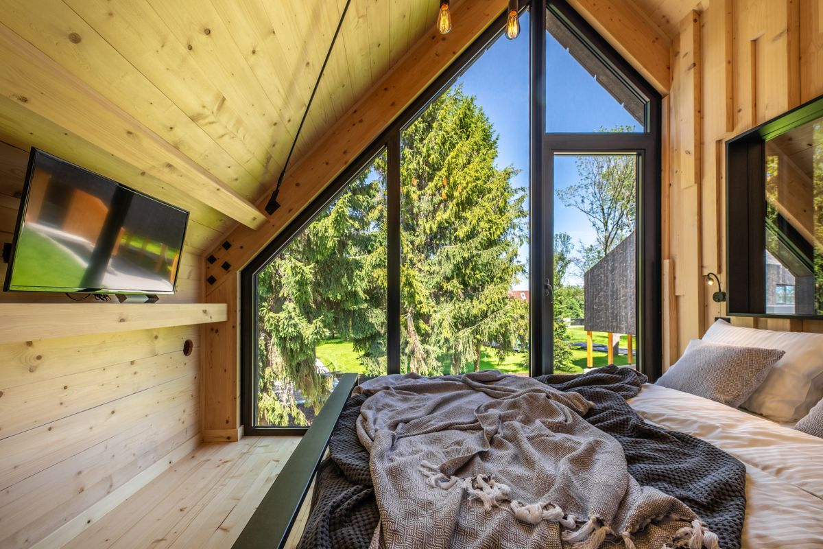 Although small, the bedroom doesn't look or feel tiny thanks large windows