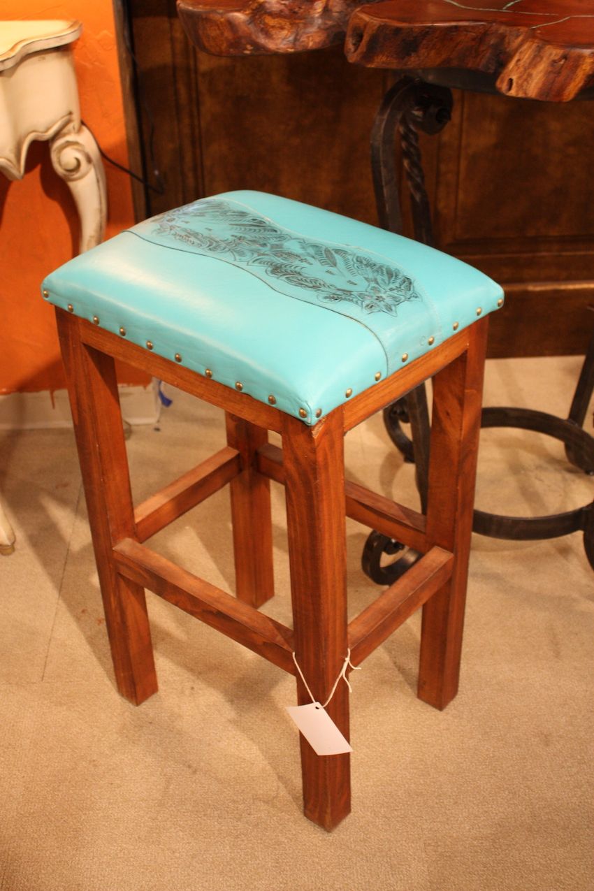 Small leather pieces like this barstool from Bell Rustica add flair to a room.