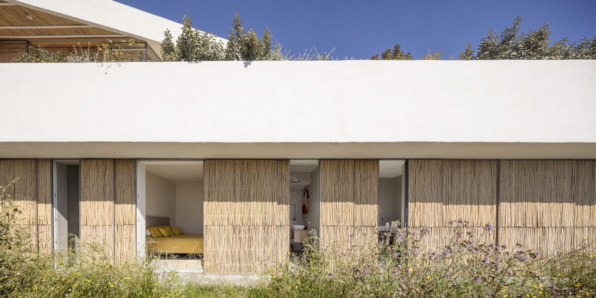 A series of sliding panels allow the interior spaces to open up towards the garden
