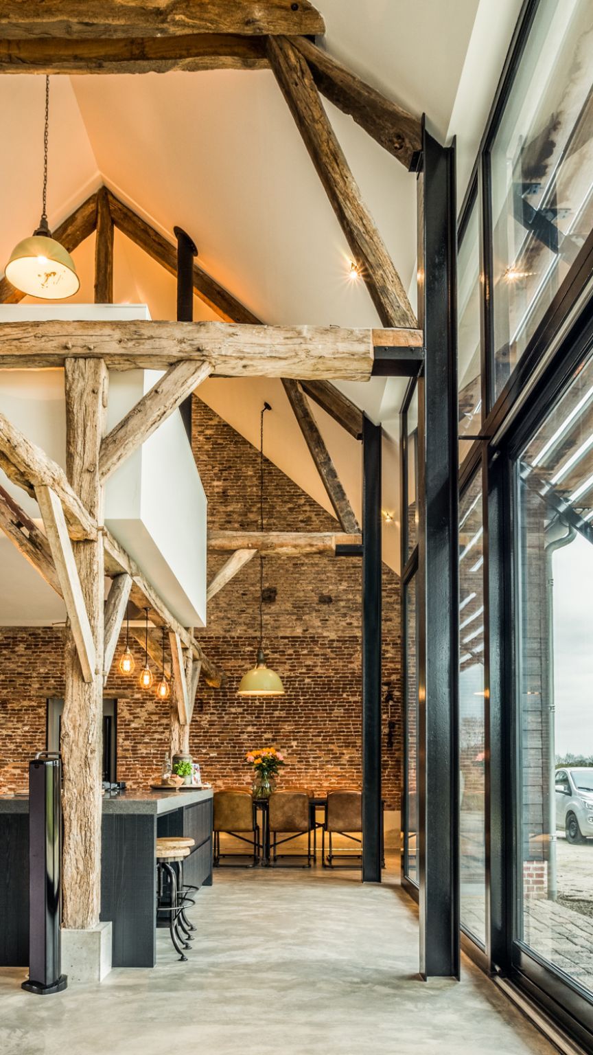 The wooden beams and brick wall give the house a rustic-industrial vibe and make it feel extra warm and cozy