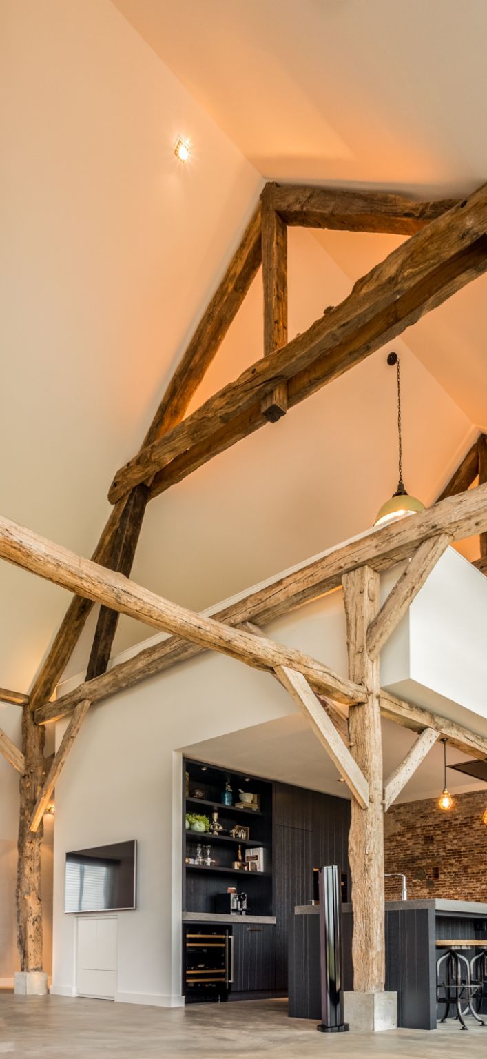 The rest of the walls have a clean white look which allows the wooden trusses to stand out even more